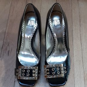 Black peep toe patent heels with gold buckles